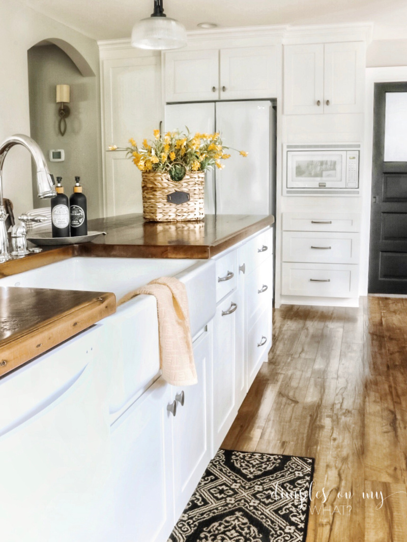 white appliances in a farmhousse kitchen; white kitchen; remodeled kitchen; farmhouse kitchen; subway backsplash in kitchen; reclaimed wood range vent hood; hood vent painted dorian gray; reclaimed wood countertop; sherwin williams repose gray kitchen