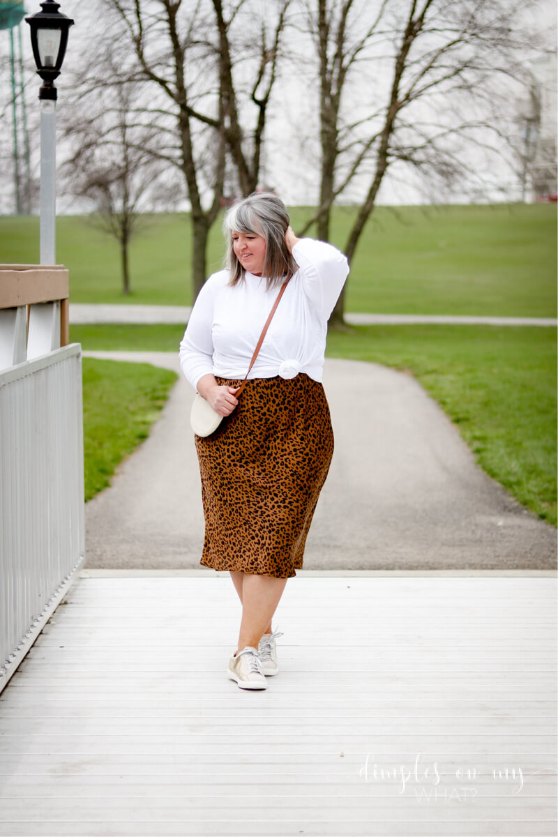 Style a Plus-Size Slip Dress with simple sneakers and a knotted long sleeve t-shirt for effortless chic at any age.