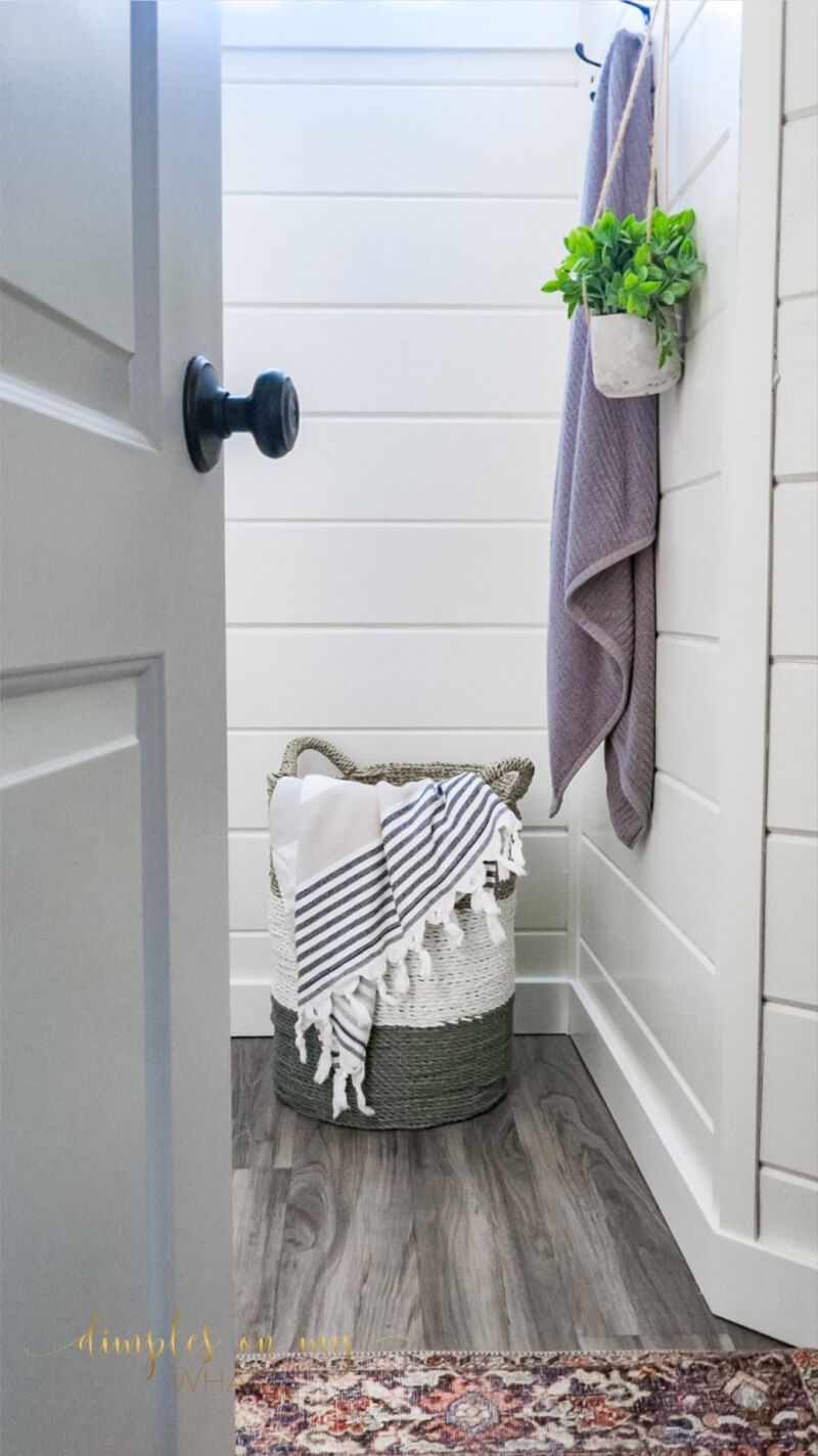 How we created a modern farmhouse bathroom retreat in dingy basement bathroom. Where we splurged and where we saved. #bathroom #bathroomremodel #diybathroomremodel #carsiding #shiplapbathroom #bathroomdecor #bathroomdecorideas #luxuryvinylplank #sherwinwilliamsalabaster #smallvesselsink