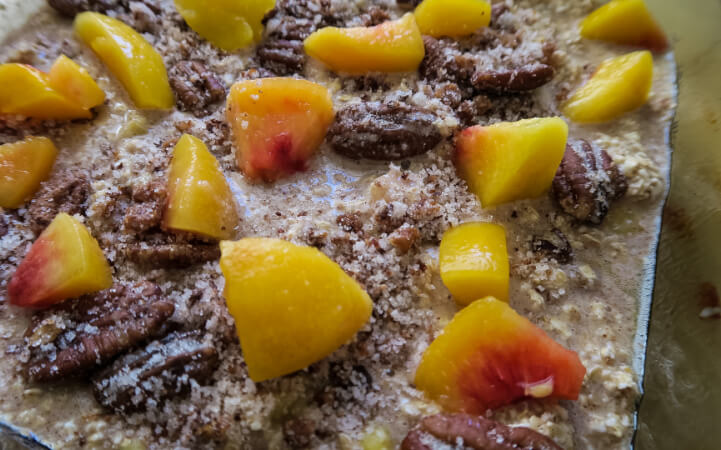 This Peach Baked Oatmeal combines tart peaches with sugar sweetened bacon for a unique twist on a brunch favorite.   #bakedoatmeal #peachbakedoatmeal #brunchrecipes #sweetandsavoryrecipes #breakfast #healthybreakfast