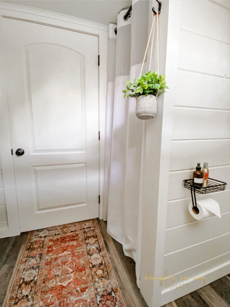 How we created a modern farmhouse bathroom retreat in dingy basement bathroom. Where we splurged and where we saved. #bathroom #bathroomremodel #diybathroomremodel #carsiding #shiplapbathroom #bathroomdecor #bathroomdecorideas #luxuryvinylplank #sherwinwilliamsalabaster #smallvesselsink