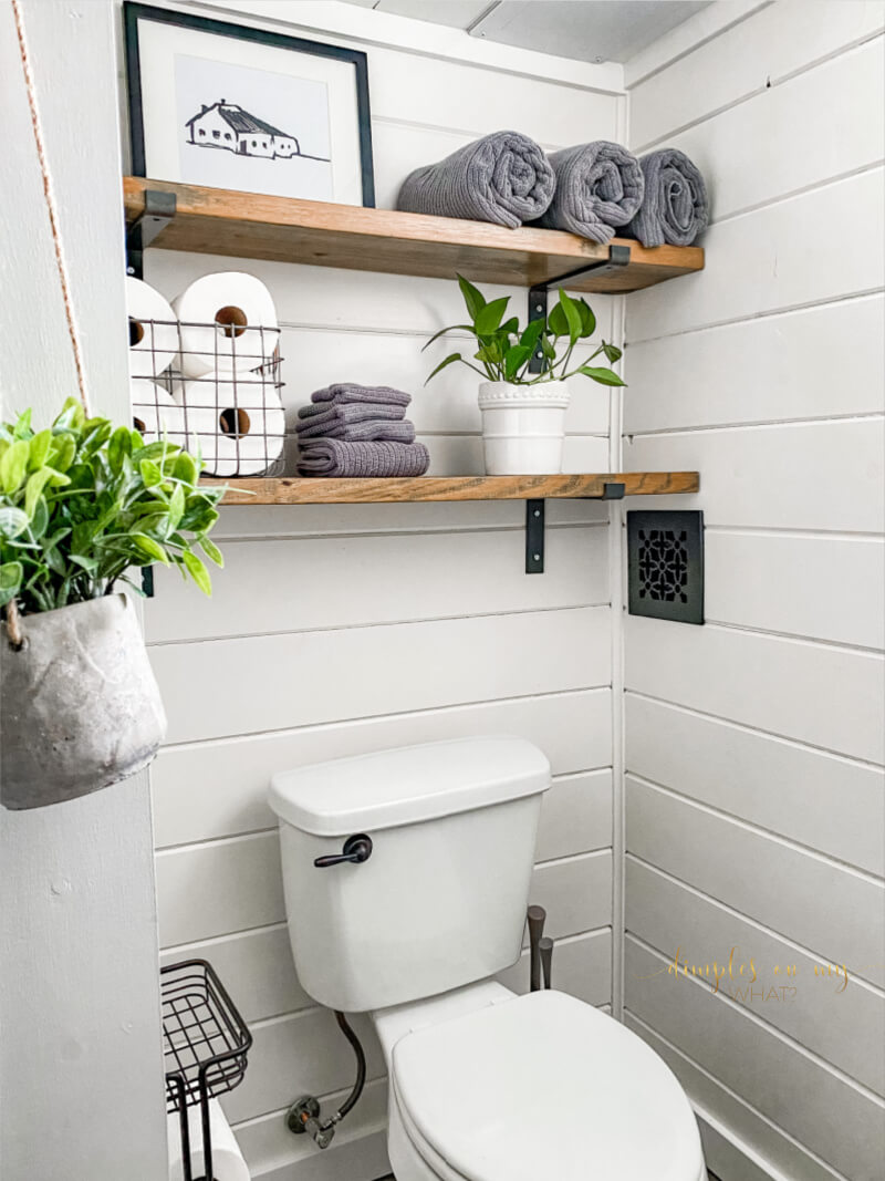 How we created a modern farmhouse bathroom retreat in dingy basement bathroom. Where we splurged and where we saved. #bathroom #bathroomremodel #diybathroomremodel #carsiding #shiplapbathroom #bathroomdecor #bathroomdecorideas #luxuryvinylplank #sherwinwilliamsalabaster #smallvesselsink