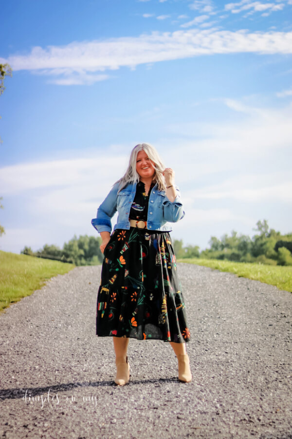 Don't put your summer dresses away when the weather starts to cool down. Booties and jean jackets can transform them into the perfect fall outfit. #midsize #midsizefalloutfit #falloutfitinspiration #transitionalfashion #plussize #fashionforwomenover50 #longgrayhairstyles
