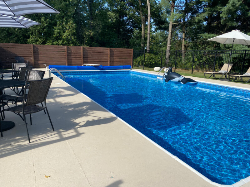 Resurfacing concrete is expensive no matter what material you use. But we did it ourselves and save a lot of money. Here's how we resurfaced our concrete for less. #poolconcrete #coolpooldeckcoating #concreteresurfacing #paintingconcrete #pooldecor