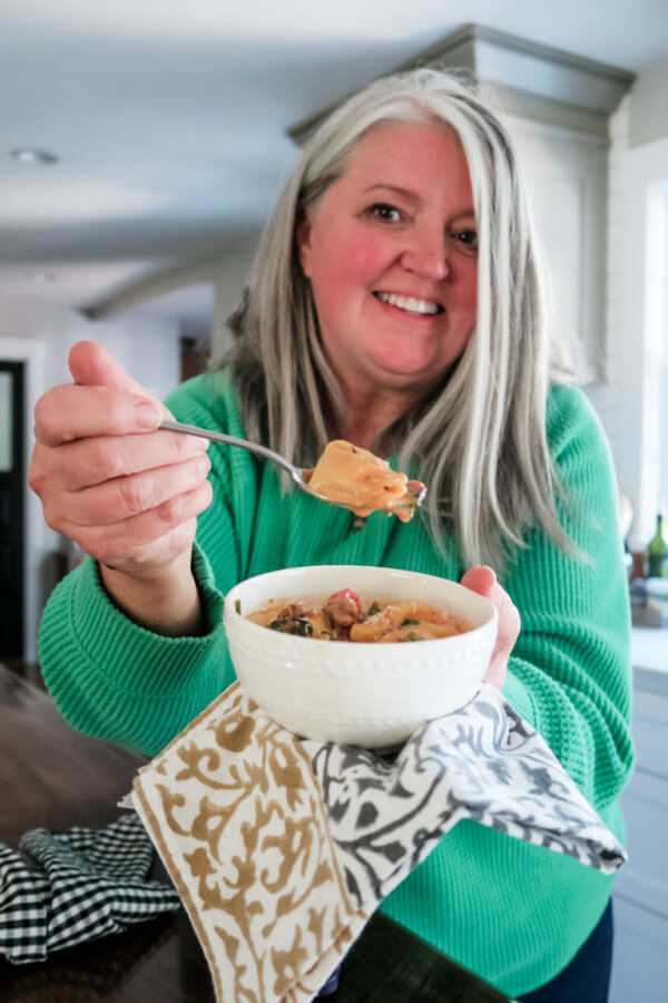 Bowl of creamy sausage tortellini soup with cheese tortellini and spinach
