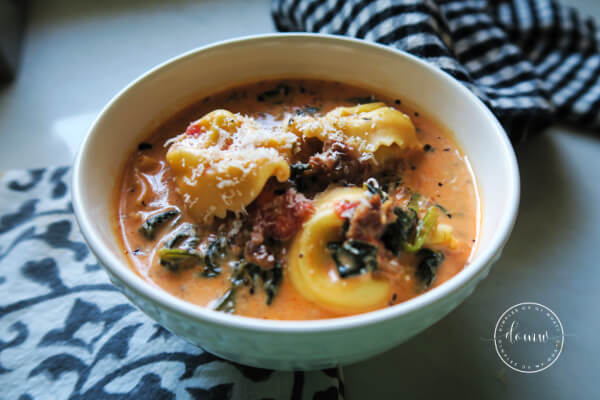 Creamy Italian sausage tortellini soup with spinach served in a bowl