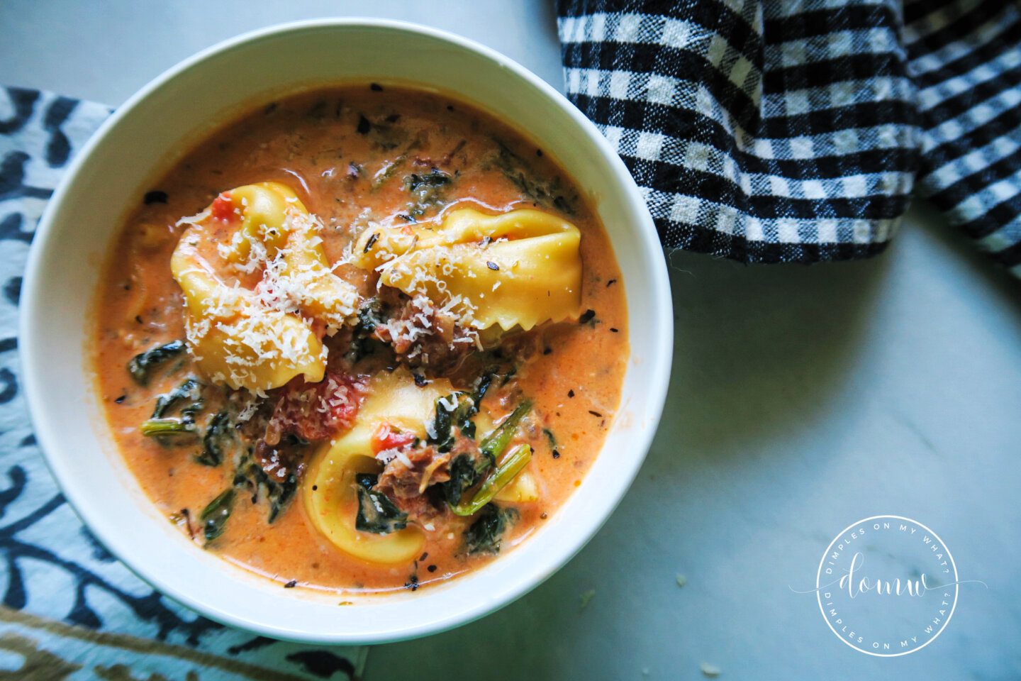 Creamy Italian sausage tortellini soup with spinach served in a bowl